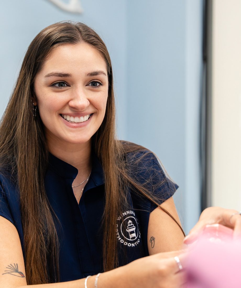 Team member smiling with a patient during a visit