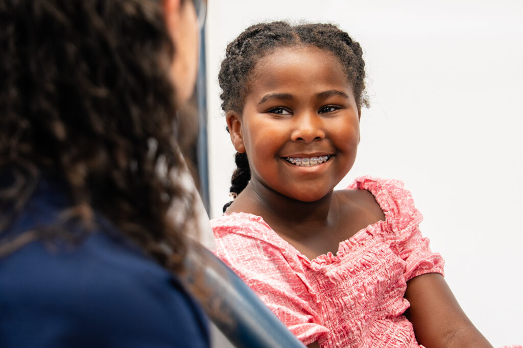 Young girl smiling in the chair at her orthodontic visit