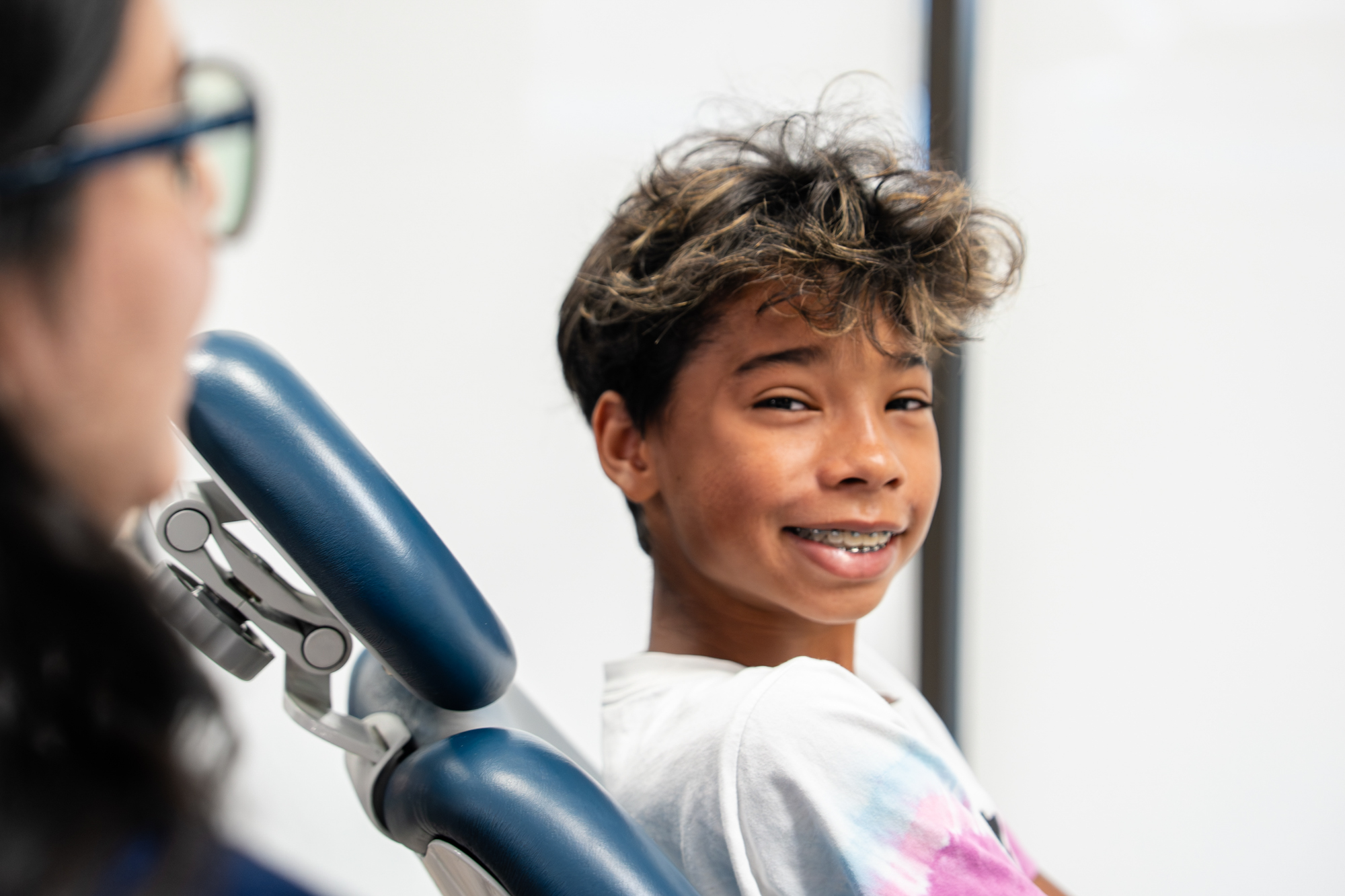 Teen patient with metal braces smiling during an orthodontic visit