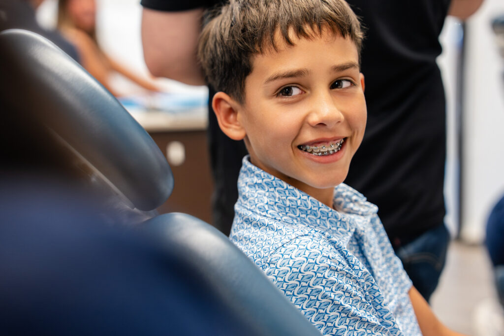 Young patient smiling in the chair with his braces